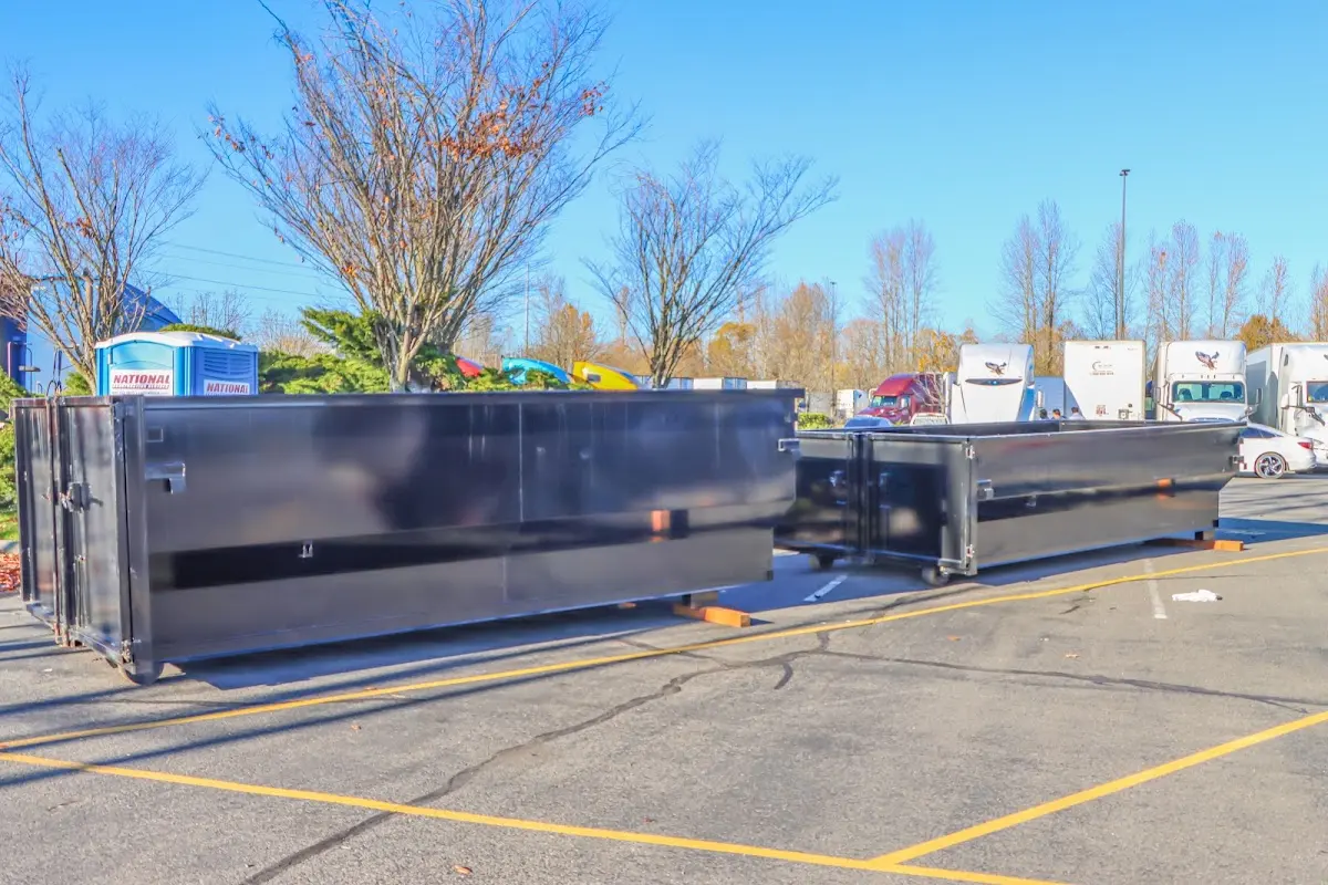 Professional dumpster rental service with roll-off container on residential driveway in Dundee